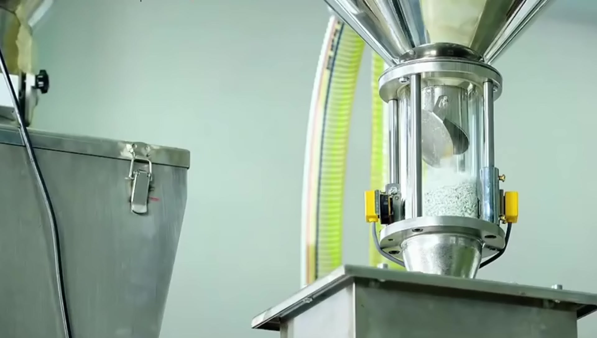 Customer-supplied company-film still showing resin handling at production equipment
