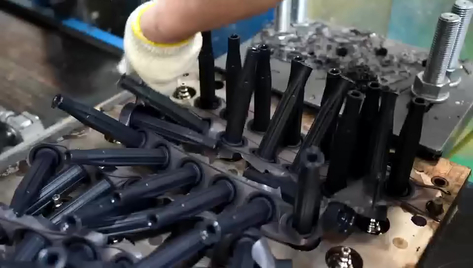 Customer-supplied company-film still showing molded parts at first-off handling