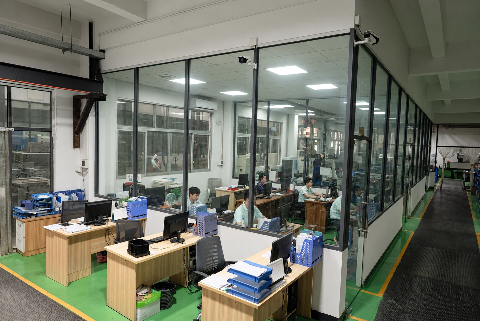 Engineering office beside the moldmaking floor with project teams at work