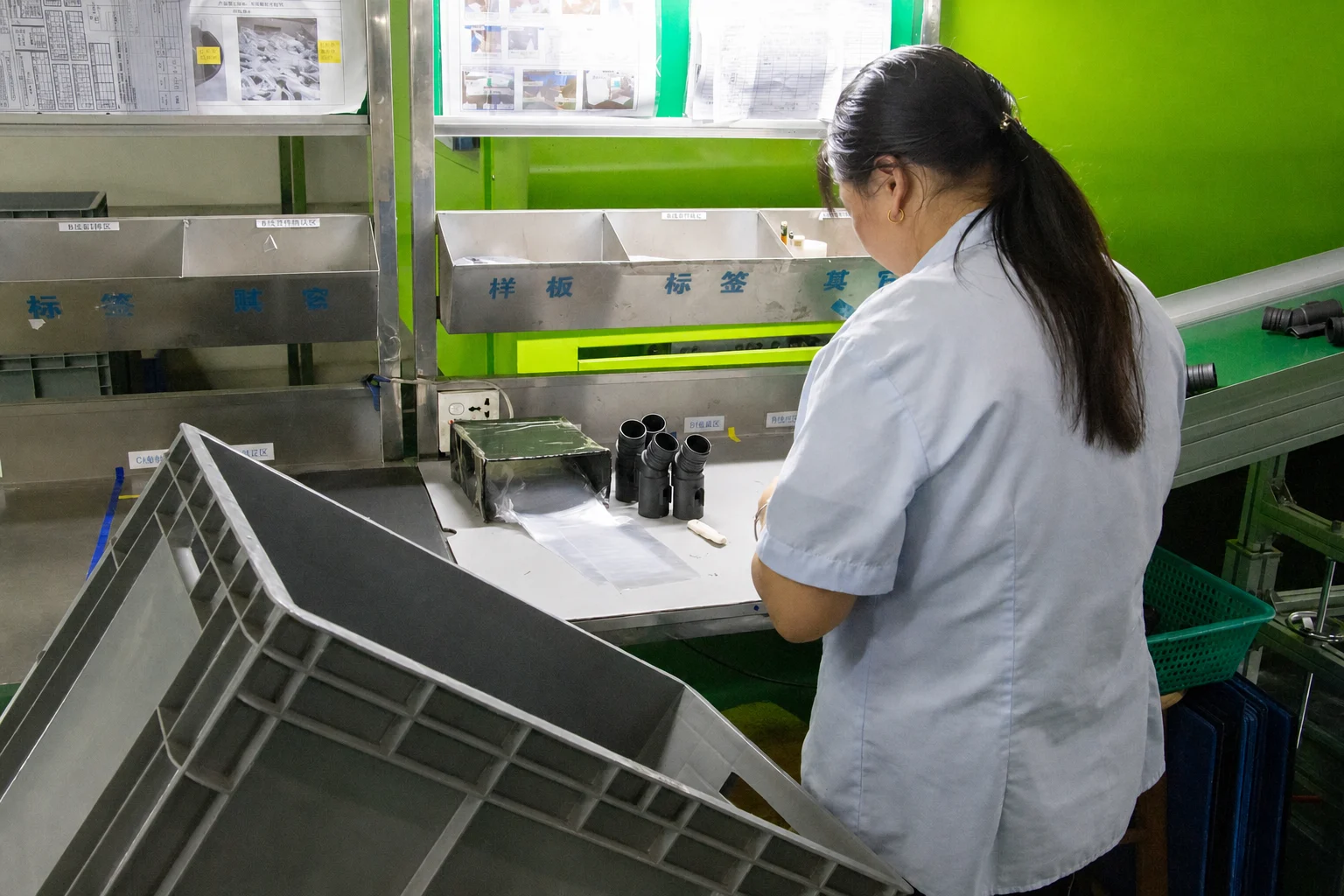 Quality technician inspecting molded components at a controlled workbench