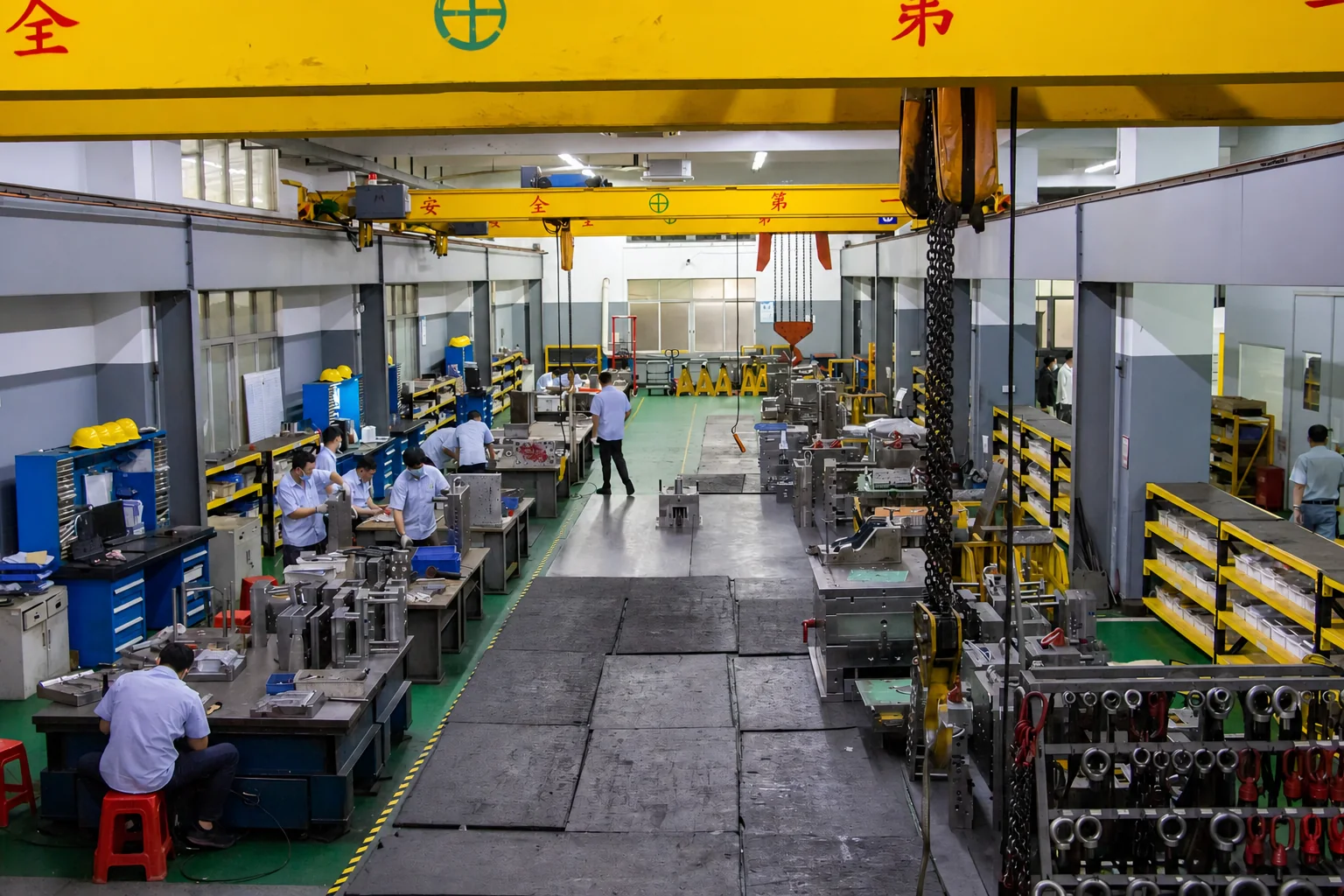 Mold assembly floor with tooling benches, lifting equipment and molds under preparation