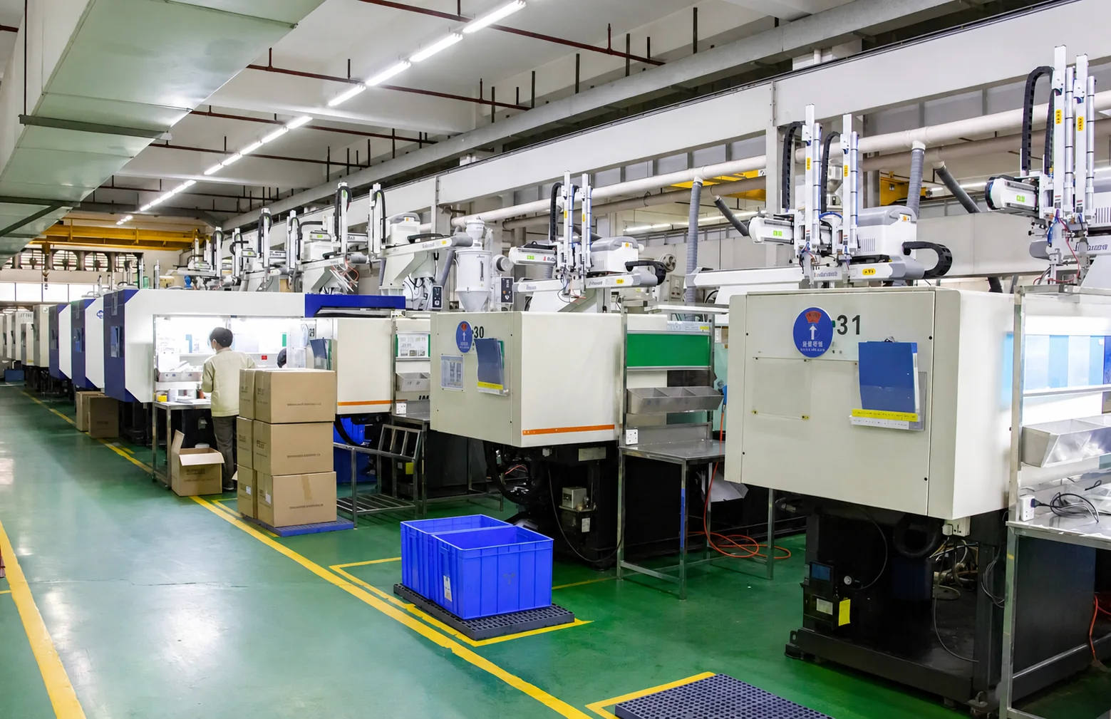 Injection molding production line with automated take-out robots and material handling