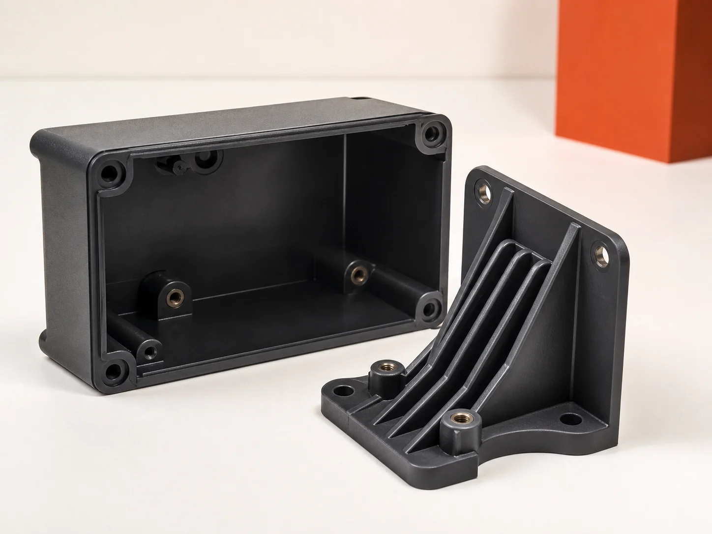 Representative molded plastic enclosure and reinforced bracket geometry
